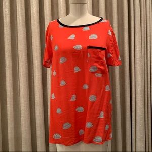 Anthropologie orange top with hats motif